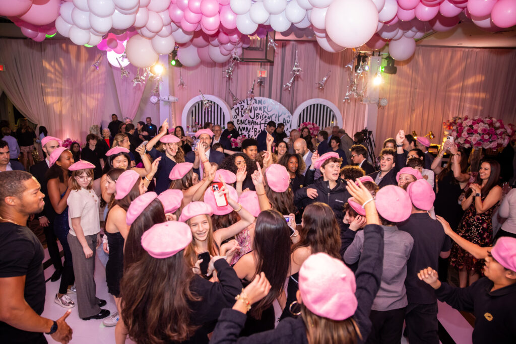 full dance floor with guests wearing berets